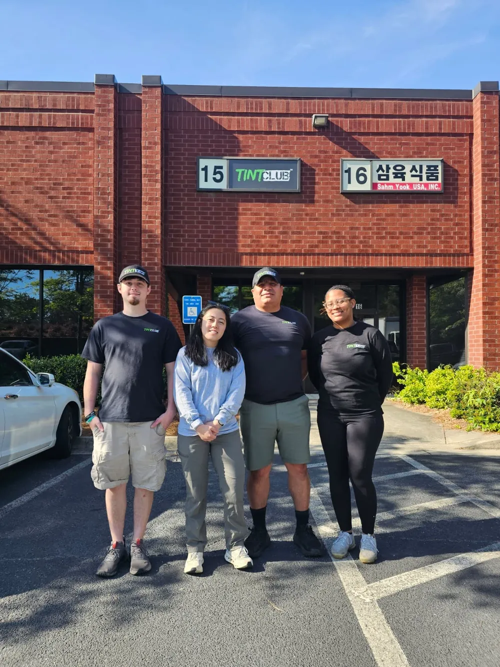 Tint Club team in front of the shop