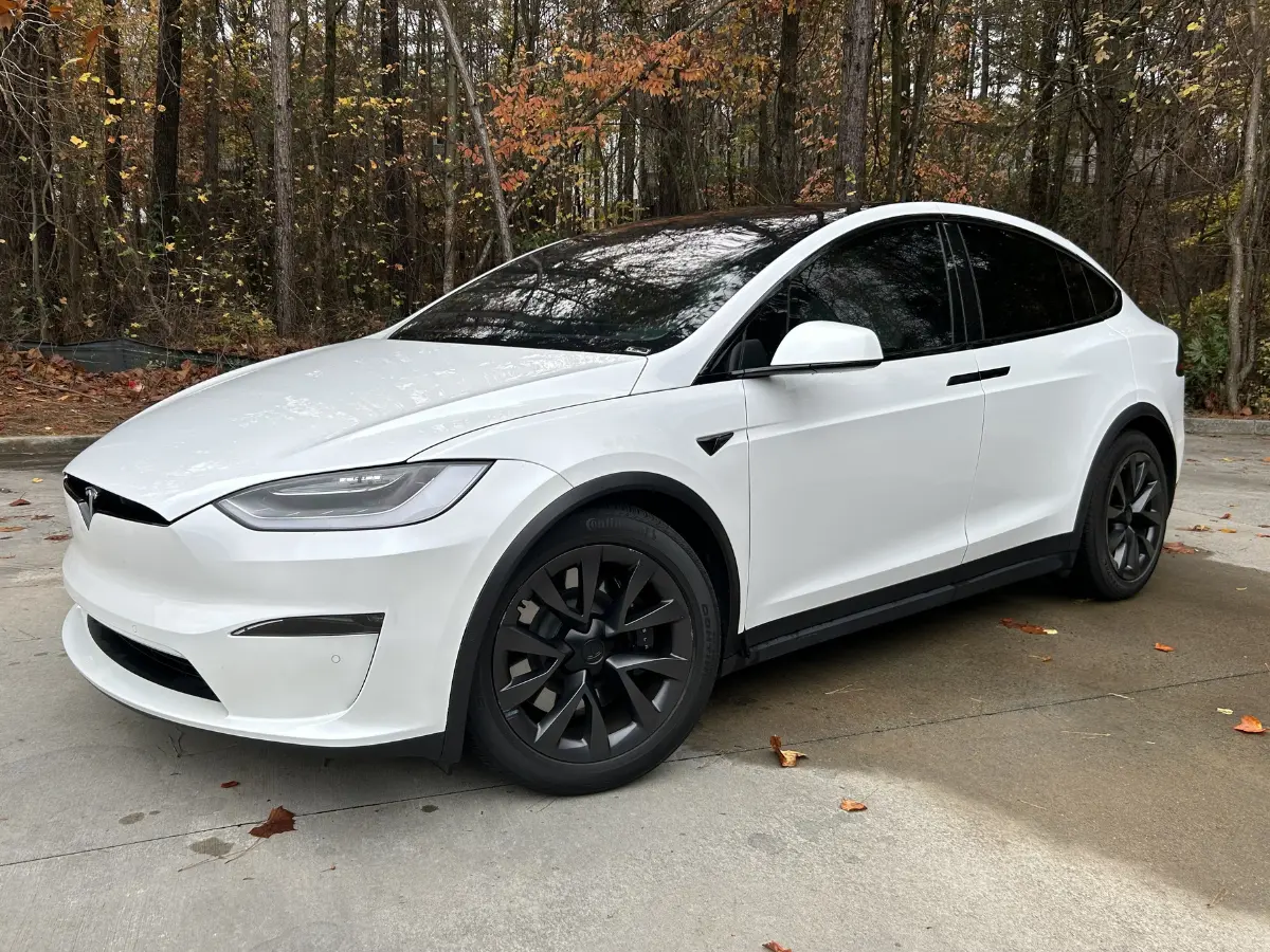 white tesla with very dark tinted windows